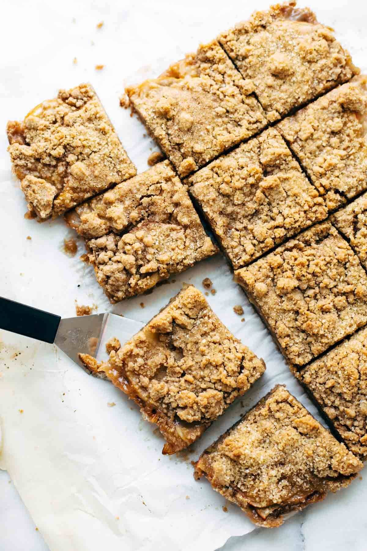 Caramel apple crisp bars with spatula.