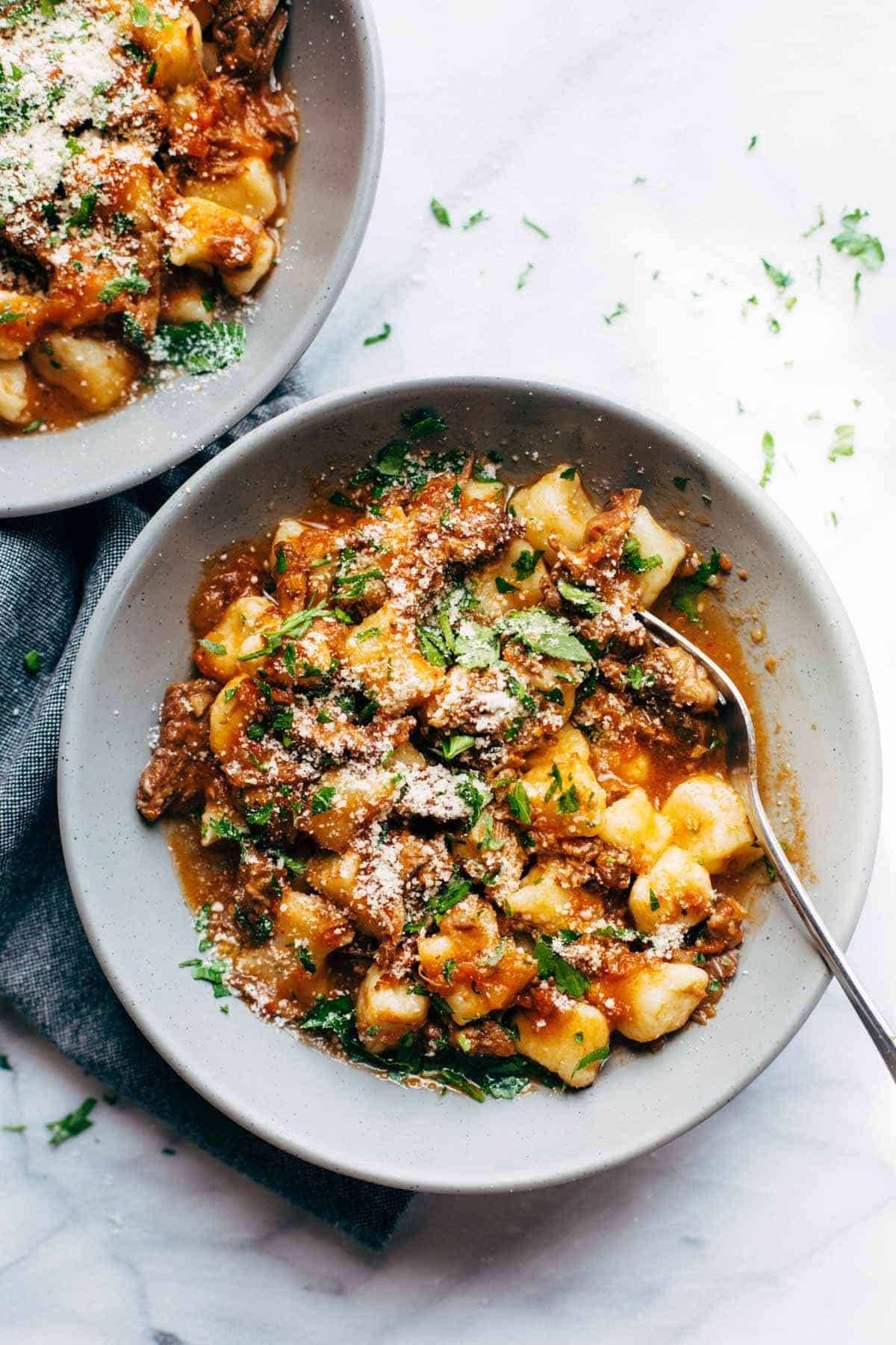 Short Rib Ragu in bowls with fork.