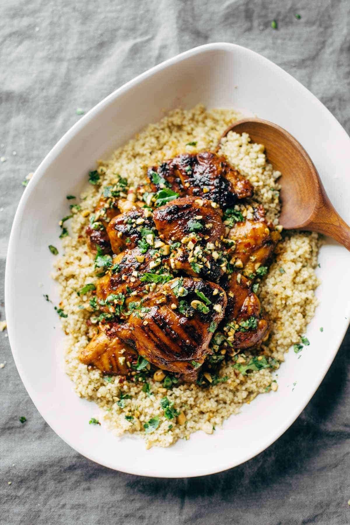 Thai chicken on a platter of quinoa.